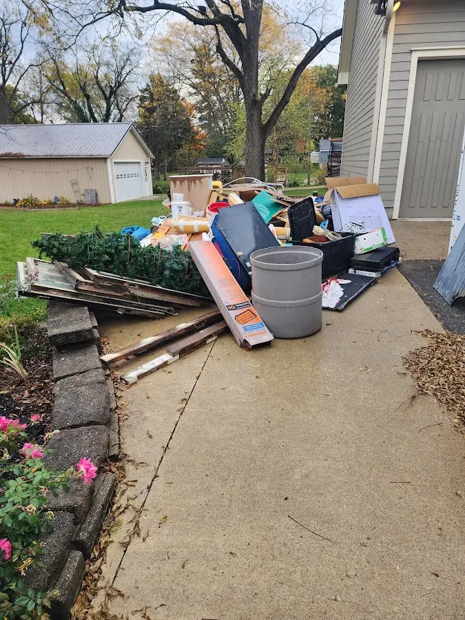 Dumpster being loaded with debris for Estate Cleanout Dumpster Rental in Barrington